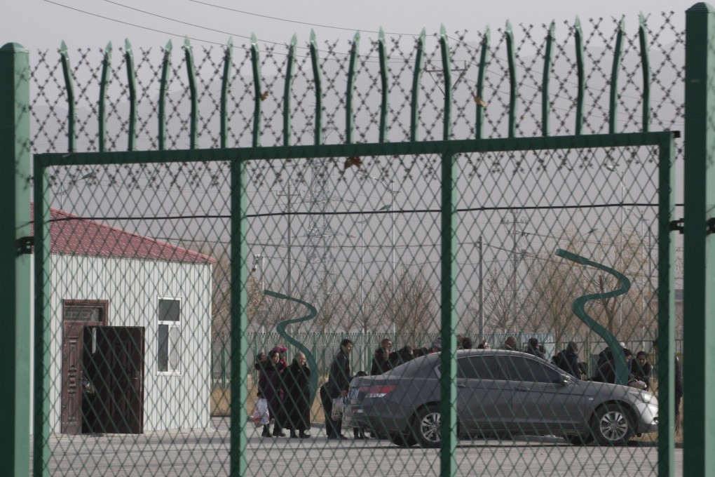 Residents line up inside a so-called vocational training centre that has previously been revealed by leaked documents to be a forced indoctrination camp. Photo: AP