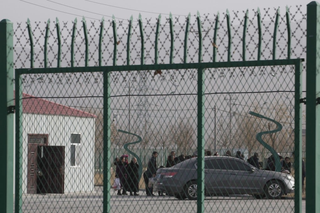 Residents line up inside a so-called vocational training centre that has previously been revealed by leaked documents to be a forced indoctrination camp. Photo: AP