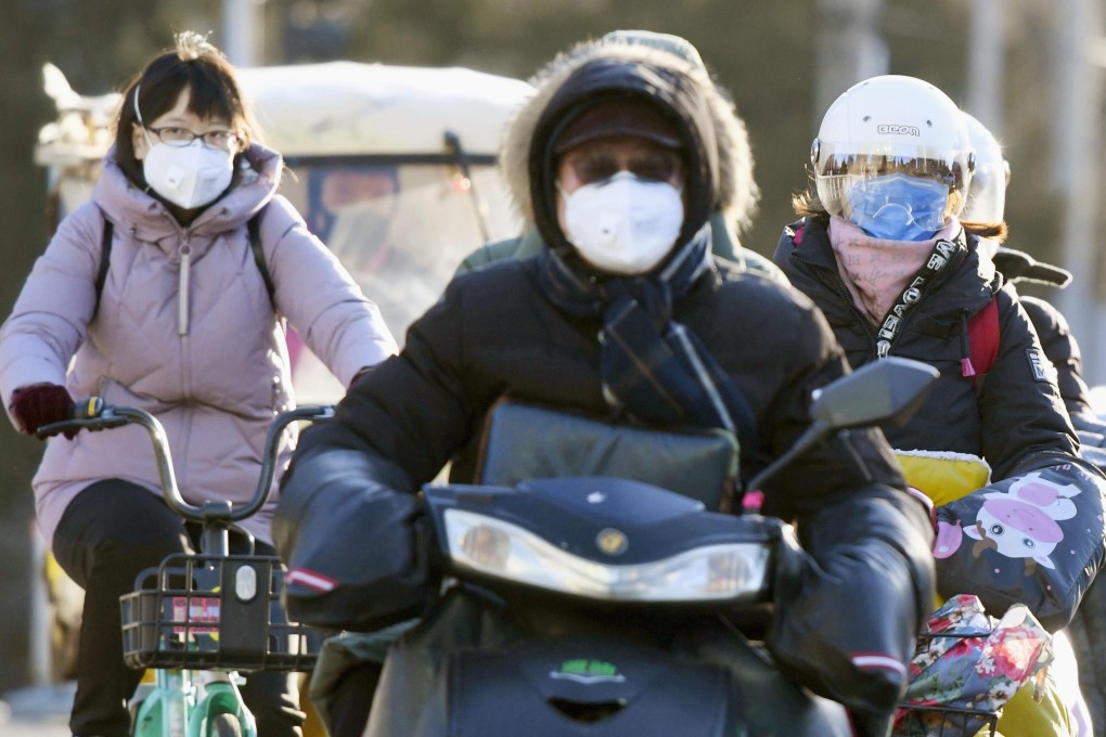 Motorists wearing masks in Beijing. Photo: Kyodo