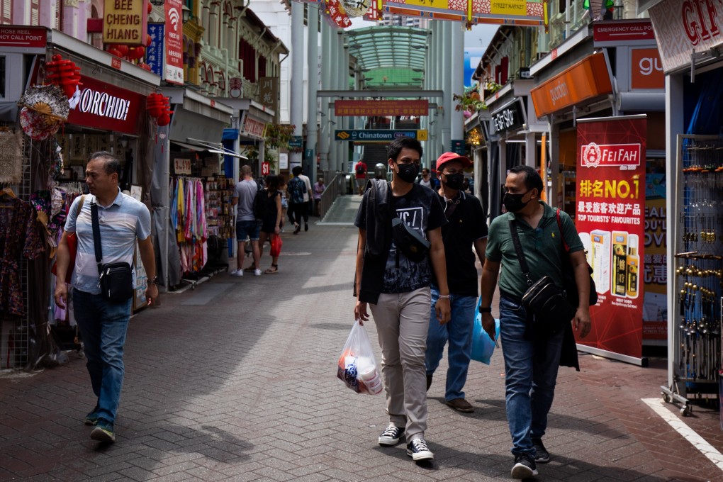 People wearing protective masks walk through the Chinatown area of Singapore. Photo: Bloomberg