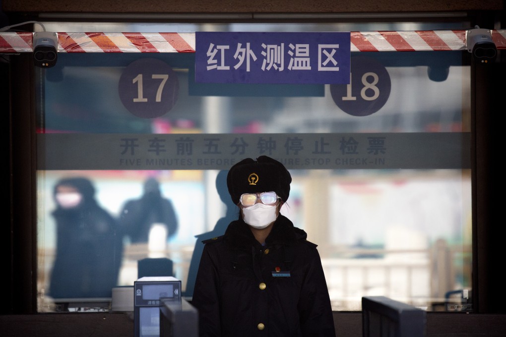 A station worker in face mask and goggles waiting to check passengers’ tickets at Beijing railway station. Travel restrictions are in place across much of China as authorities battle to contain the coronavirus. Photo: AP