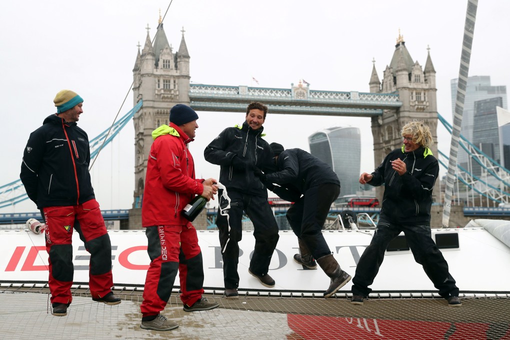Sailor Francis Joyon sprays champagne at his crew on board of the IDEC SPORT after their arrival at Butler's Wharf in London. Photo: Reuters