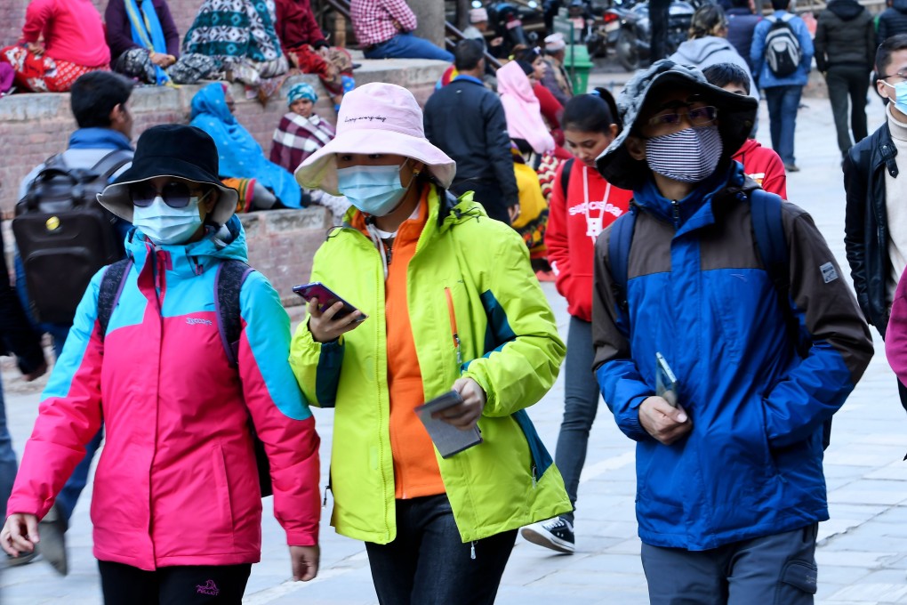 Pedestrians wearing face masks in Kathmandu. Photo: AFP