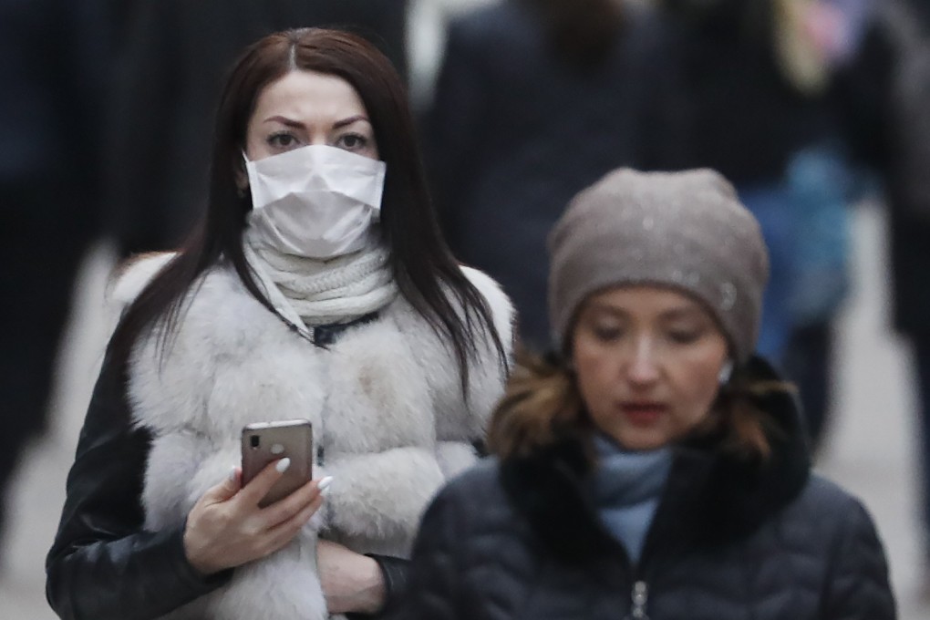 A woman wears a protective mask on the street in downtown Moscow on Wednesday. Photo: EPA-EFE