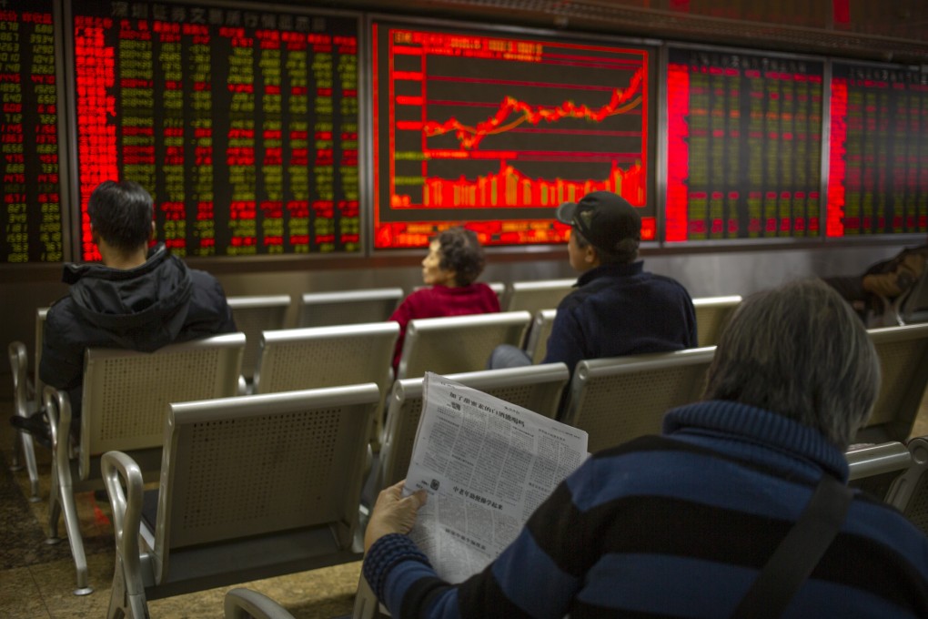 Investors monitor stock prices at a brokerage house in Beijing. The Shanghai Composite Index reaches a one-month high on February 20. Photo: AP