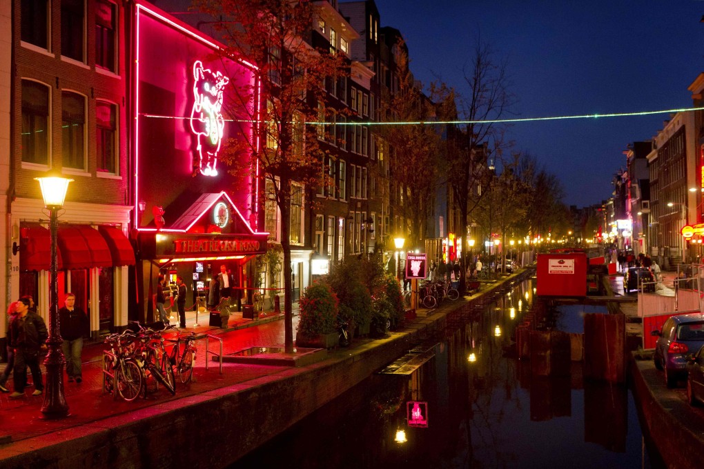 People walk through the red-light district, known as De Wallen, in Amsterdam. Photo: AFP