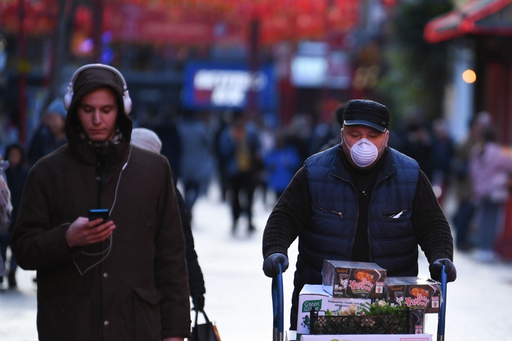 A worker wears a mask in London's Chinatown district. Photo: AFP