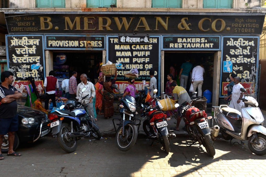 Mumbai's historic Irani cafes, like B. Merwan & Co, are slowly disappearing, but owners are determined to keep the tradition of rich and poor sitting side by side to eat Indian fast-food favourites. Photo: Hindustan Times via Getty Images