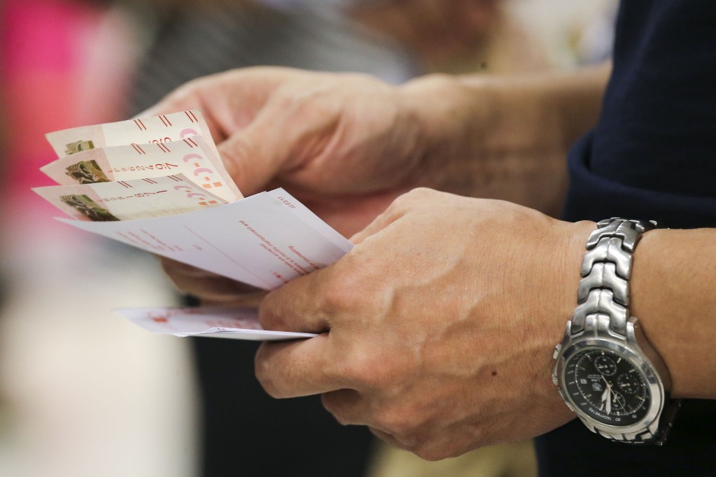 People queue up to place their bets for the Mark Six draw at a Hong Kong Jockey Club outlet in Central in 2017. Photo: Dickson Lee