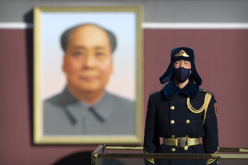 A member of a Chinese honour guard wears a face mask as he stands guard on Tiananmen Square in Beijing. Photo: AP