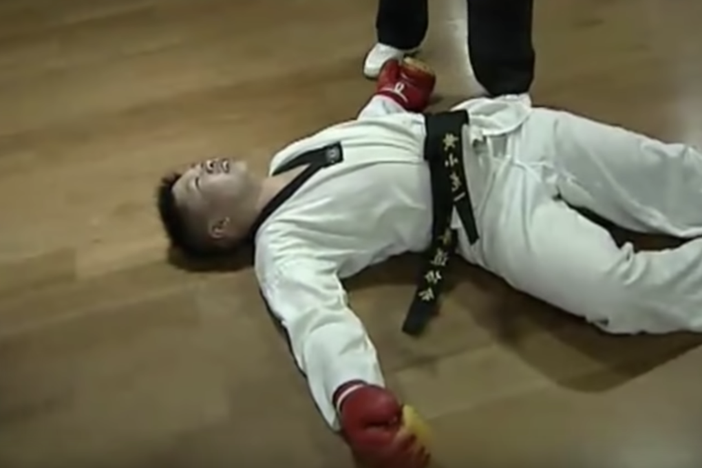 Chinese World Taekwondo Federation black belt Huang Xiaolong lies concussed on the floor. Photo: YouTube/Fight Commentary Breakdowns