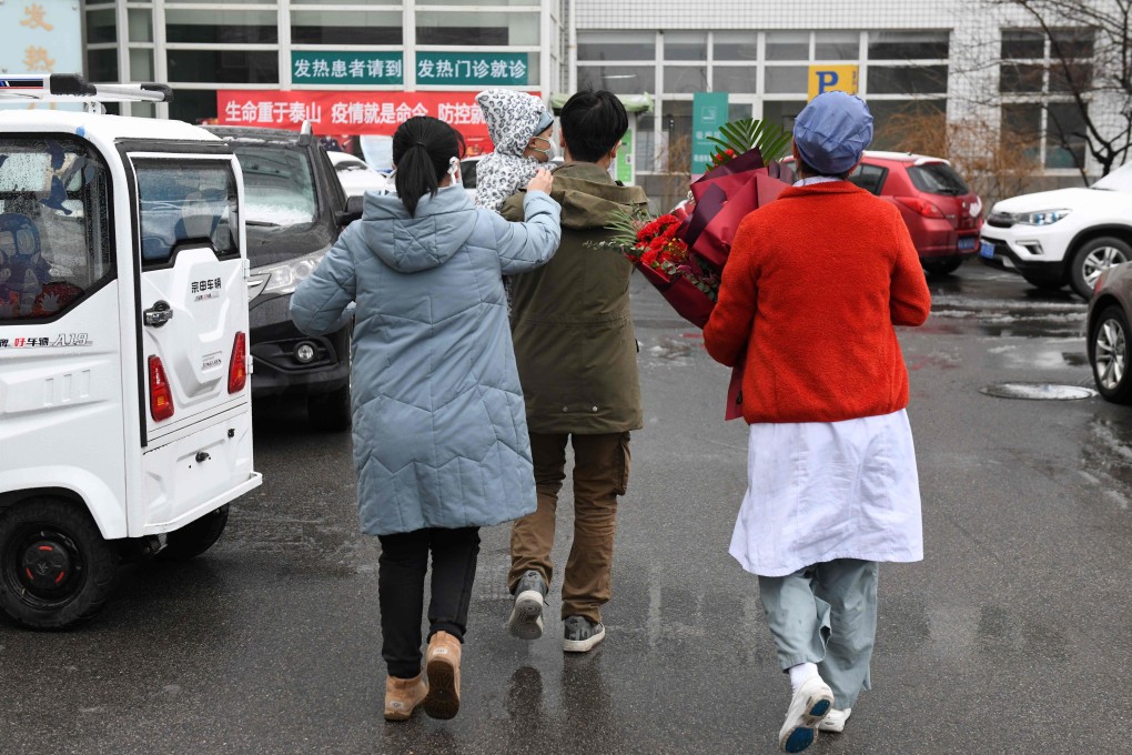A nurse accompanies a one-year-old boy and his parents as they leave Youan hospital in Beijing. Photo: AFP