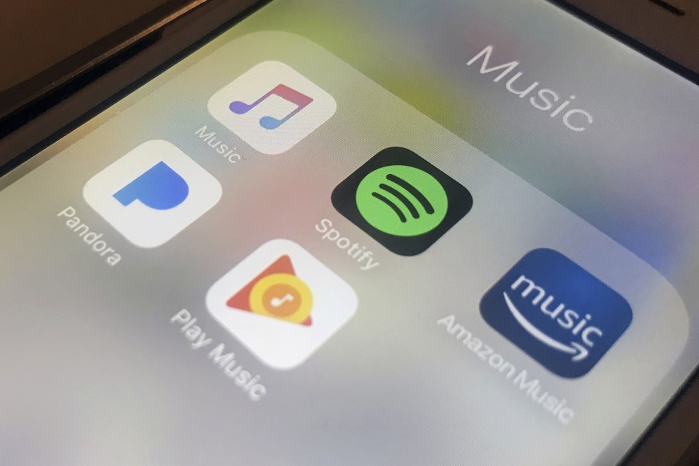 File photo showing music streaming apps clockwise from top left, Apple, Spotify, Amazon, Pandora and Google on an iPhone in New York. Photo: AP