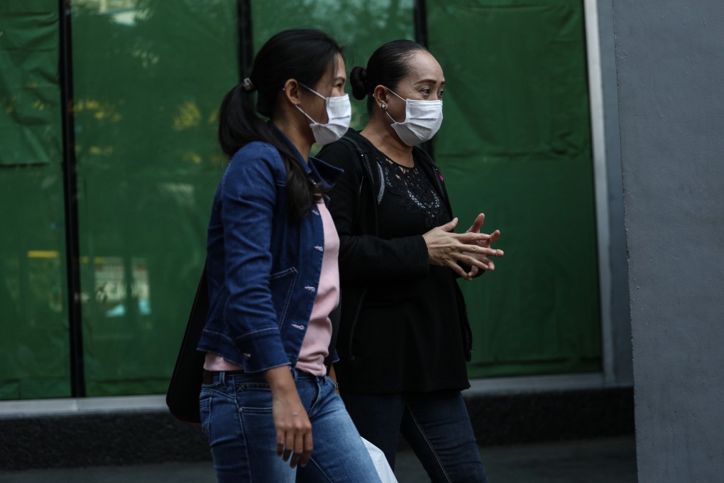 Relatives of Filipino crew members stranded on board the Diamond Princess cruise ship come out after meeting with a local employment agency for seafarers in Manila. Photo: AFP