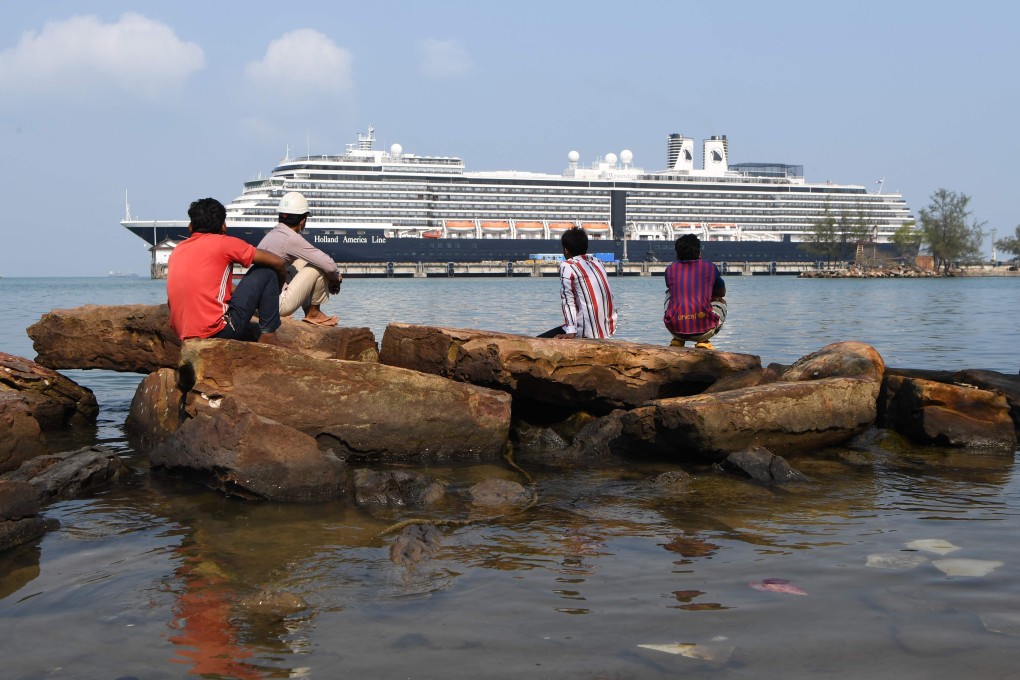 People on shore look at the Westerdam cruise ship docked in Sihanoukville on Thursday. Photo: AFP