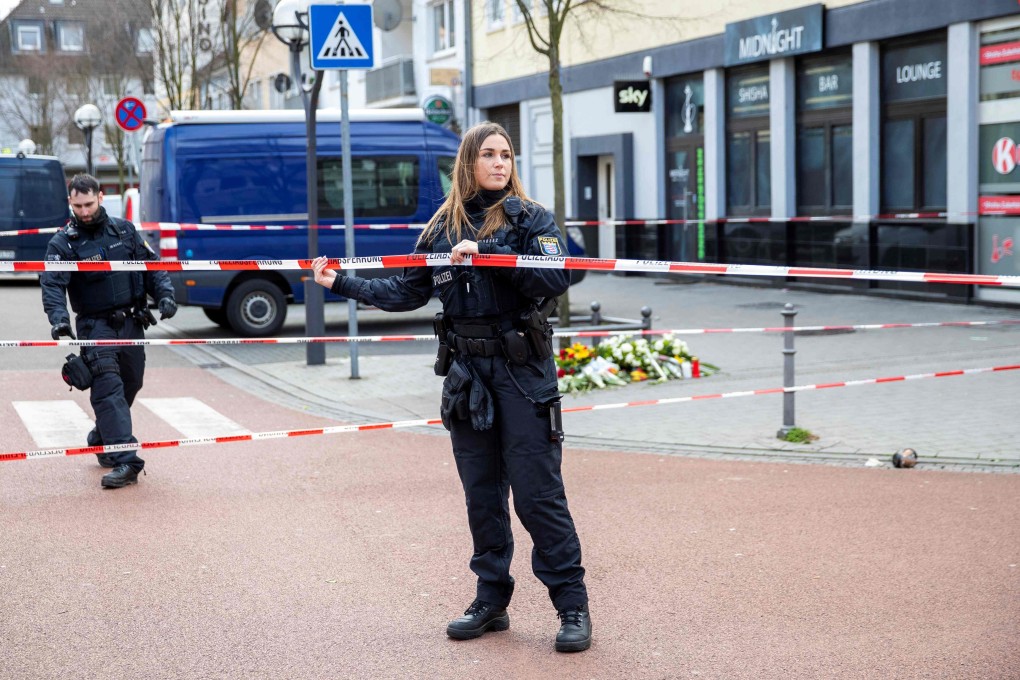Police officers cordon off the street in front of the Midnight shisha club in Hanau. Photo: AFP