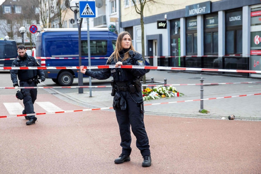 Police officers cordon off the street in front of the Midnight shisha club in Hanau. Photo: AFP