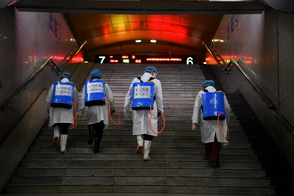 Workers prepare to sanitise a railway station in Yunnan, China, on February 4. China cannot rid the world economy of its underlying malaise. Photo: Reuters