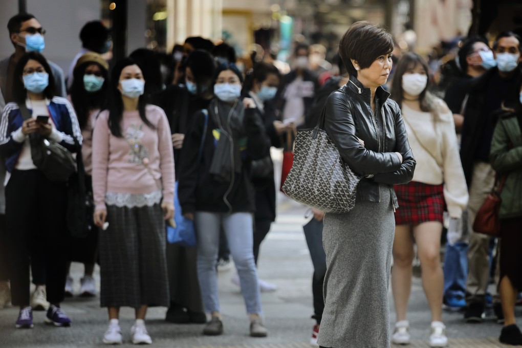 Most people in Hong Kong wear a mask while walking the streets, while a small but striking minority do not. Photo: Martin Chan