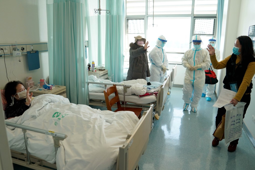 A woman in Wuhan says goodbye to other patients after recovering and being discharged from hospital. Photo: Xinhua