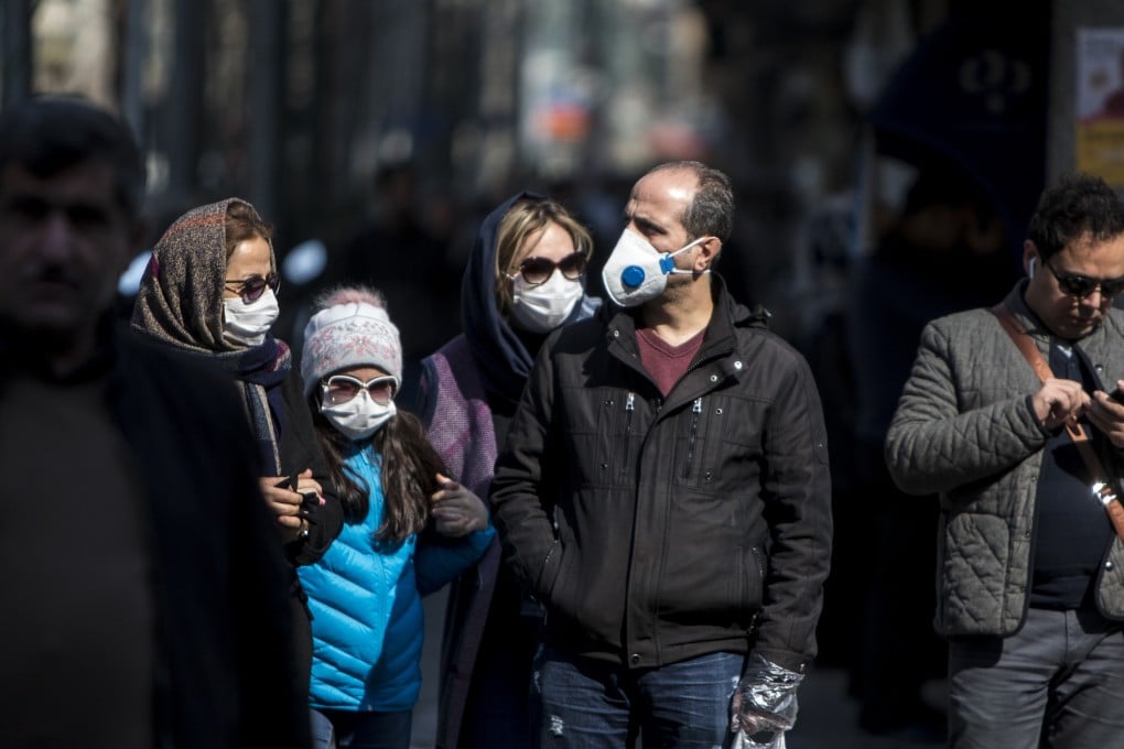 People wearing masks walk in downtown Tehran on Sunday. Photo: Xinhua