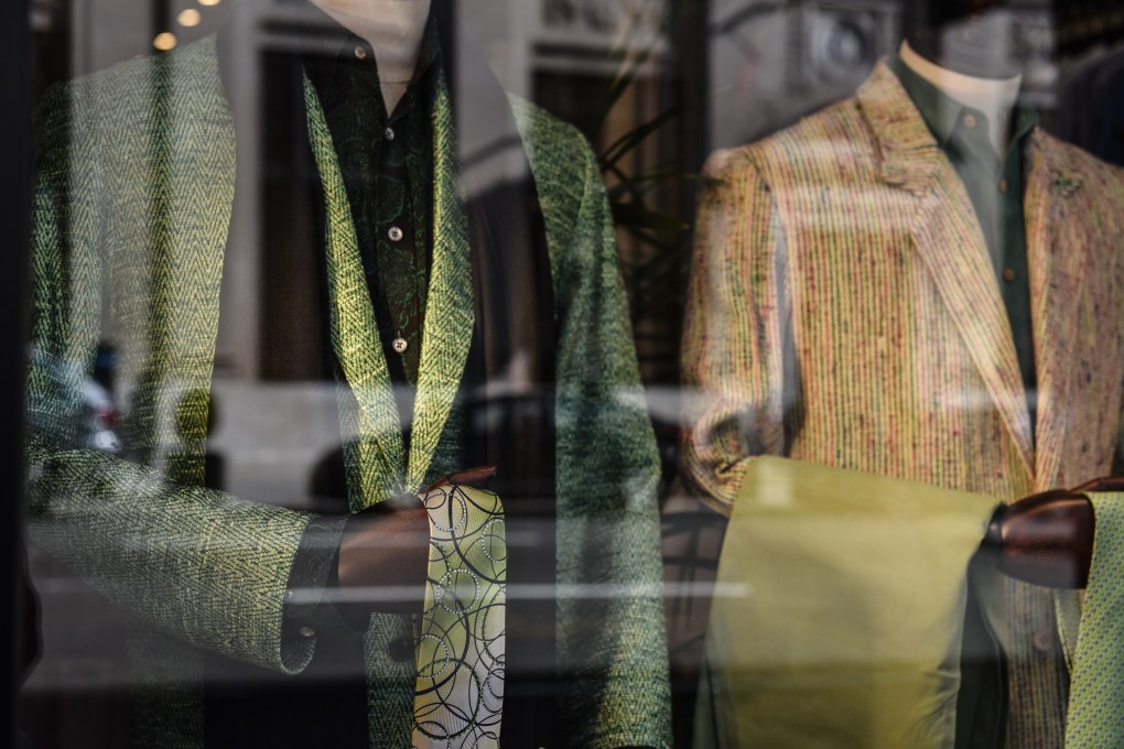 Suits are displayed in the window of a store on Madison Avenue in New York on February 17. Rebalancing US growth towards investment and exports and tempering America’s consumer-driven economy is long overdue. Photo: Bloomberg