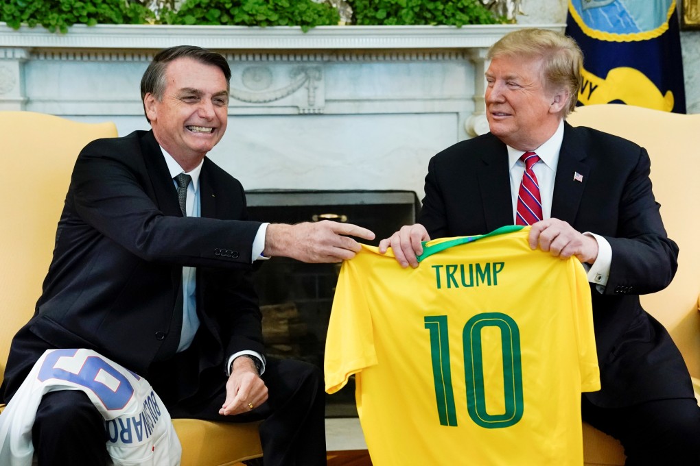 Brazil’s President Jair Bolsonaro presents a Brazil national soccer team jersey to US President Donald Trump during a meeting in the Oval Office in March 2019. Photo: Reuters