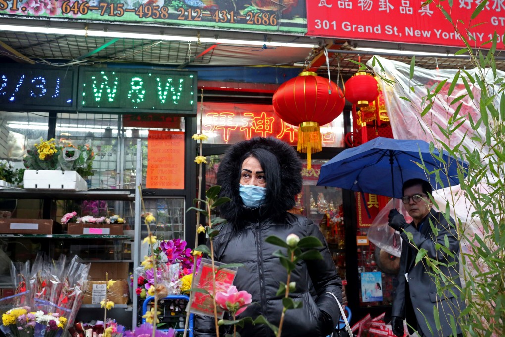 A woman, wearing a mask to protect herself against coronavirus transmission, poses for a photo in New York’s Chinatown on February 13. There are no confirmed coronavirus cases in New York City. Photo: Reuters