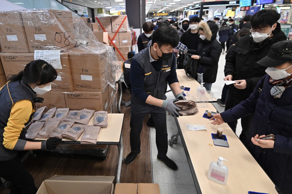 People buy face masks in the South Korean city of Daegu on Tuesday. The country has reported more than 900 coronavirus cases – the most outside China. Photo: AFP