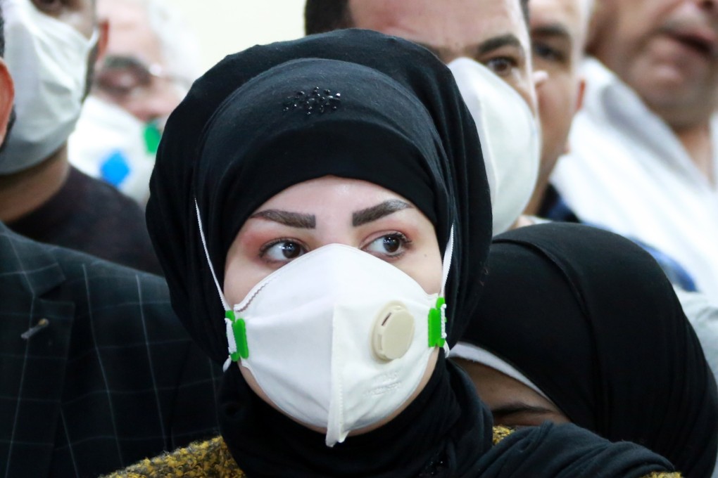 A passenger stands in a queue upon arrival from Iran at Baghdad international airport in Baghdad, Iraq on Monday. Photo: EPA