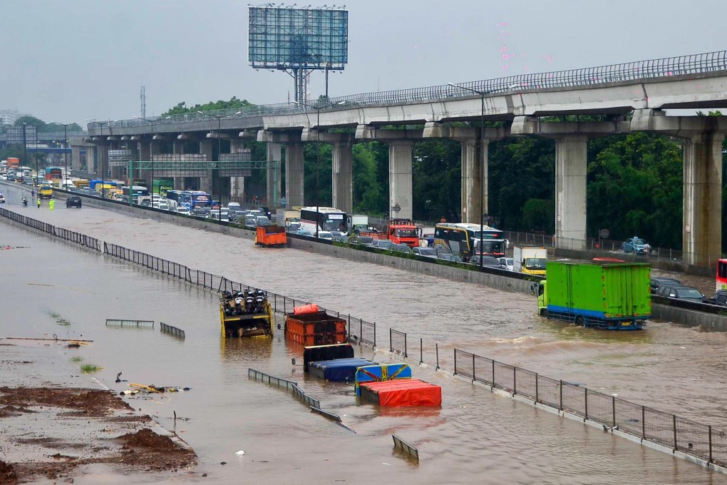 Motorists trapped on a flooded tollway after heavy rain. Photo: AFP