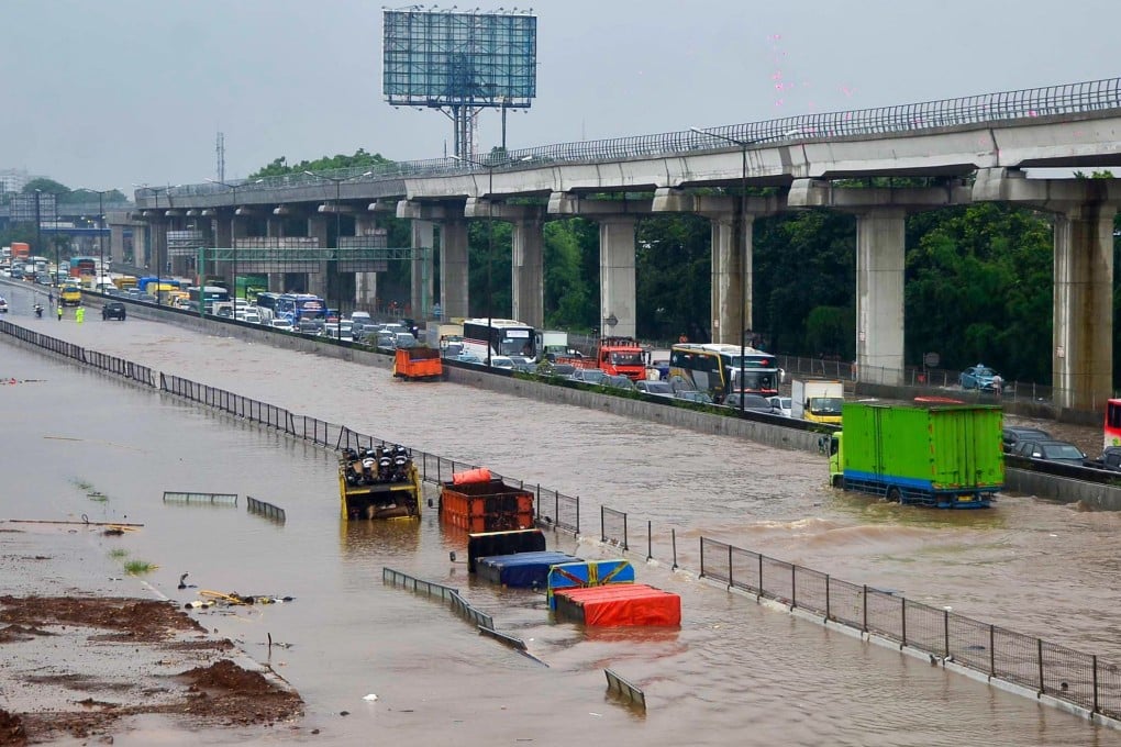 Motorists trapped on a flooded tollway after heavy rain. Photo: AFP
