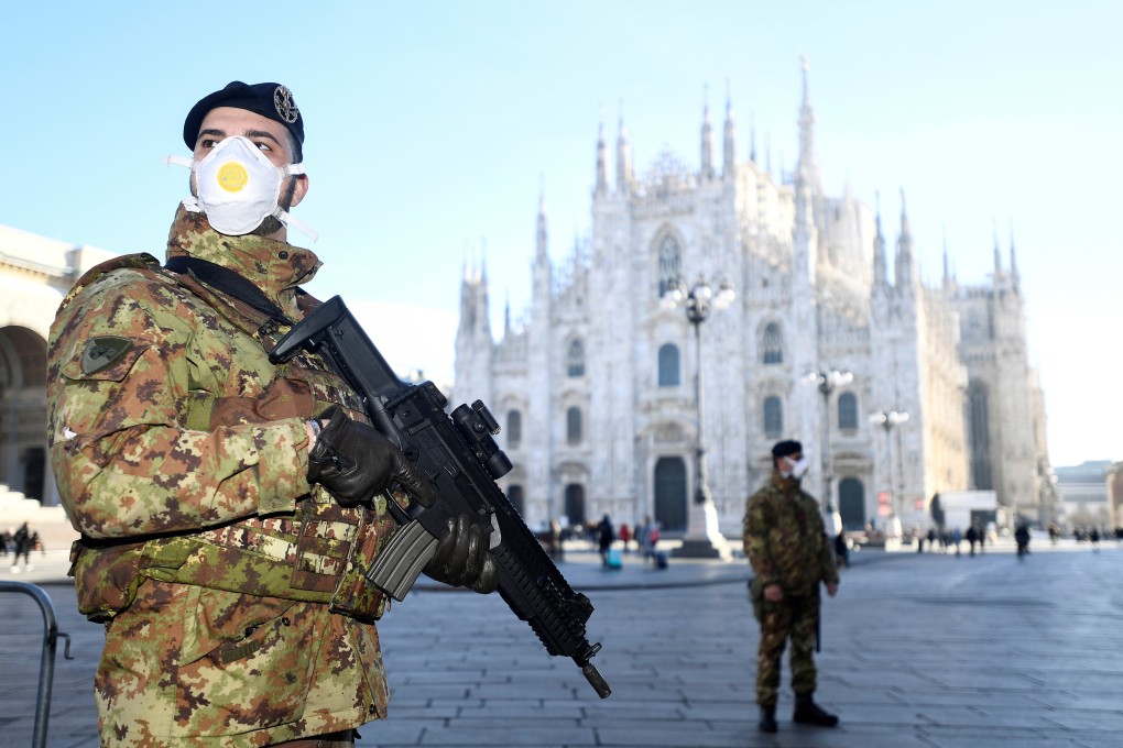 Military officers in face masks stand outside the Duomo cathedral, which was closed by authorities due to the coronavirus outbreak, in Milan on Monday. Photo: Reuters