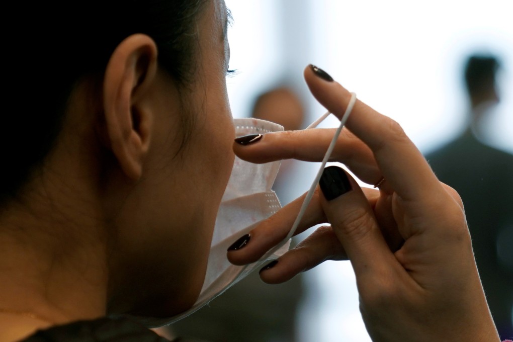 A dancer with the Shanghai Ballet puts on a mask during practice on Thursday. Two factories in Shanghai are now making reusable masks. Photo: Reuters