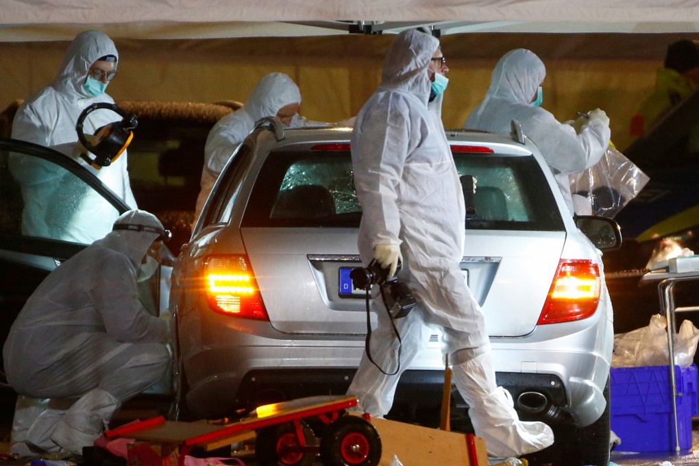 Police forensic officers examine the car involved in the incident. Photo: Reuters