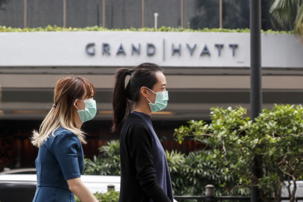 Two women in protective masks walk past a hotel in Singapore on February 7, 2020. Photo: EPA
