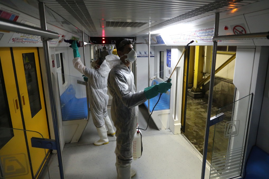 Tehran Municipality workers clean a metro train to avoid the spread of the Covid-19 illness on February 26, The outbreak in Iran has claimed 15 lives and infected nearly 100 others, including the country's deputy health minister. Photo: Agence France-Presse