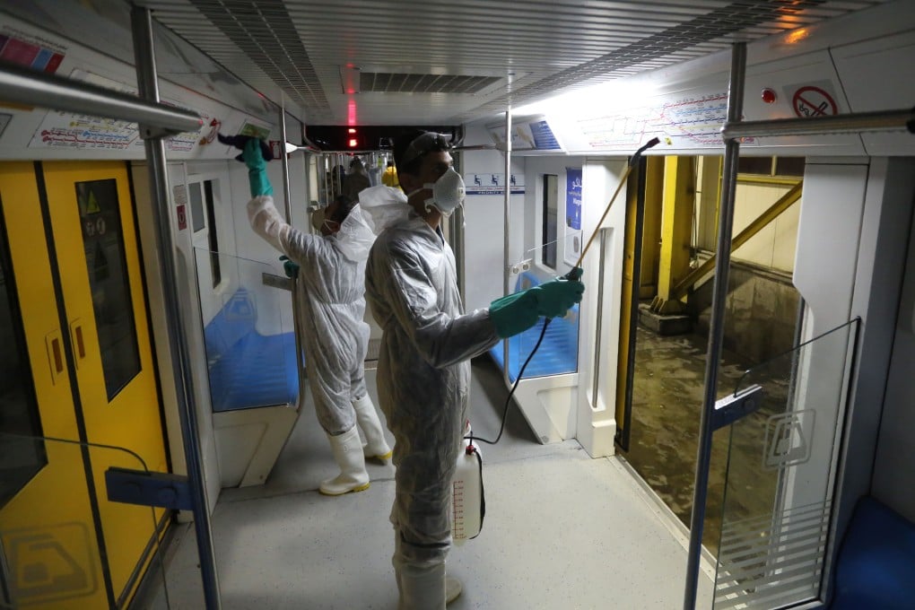 Tehran Municipality workers clean a metro train to avoid the spread of the Covid-19 illness on February 26, The outbreak in Iran has claimed 15 lives and infected nearly 100 others, including the country's deputy health minister. Photo: Agence France-Presse