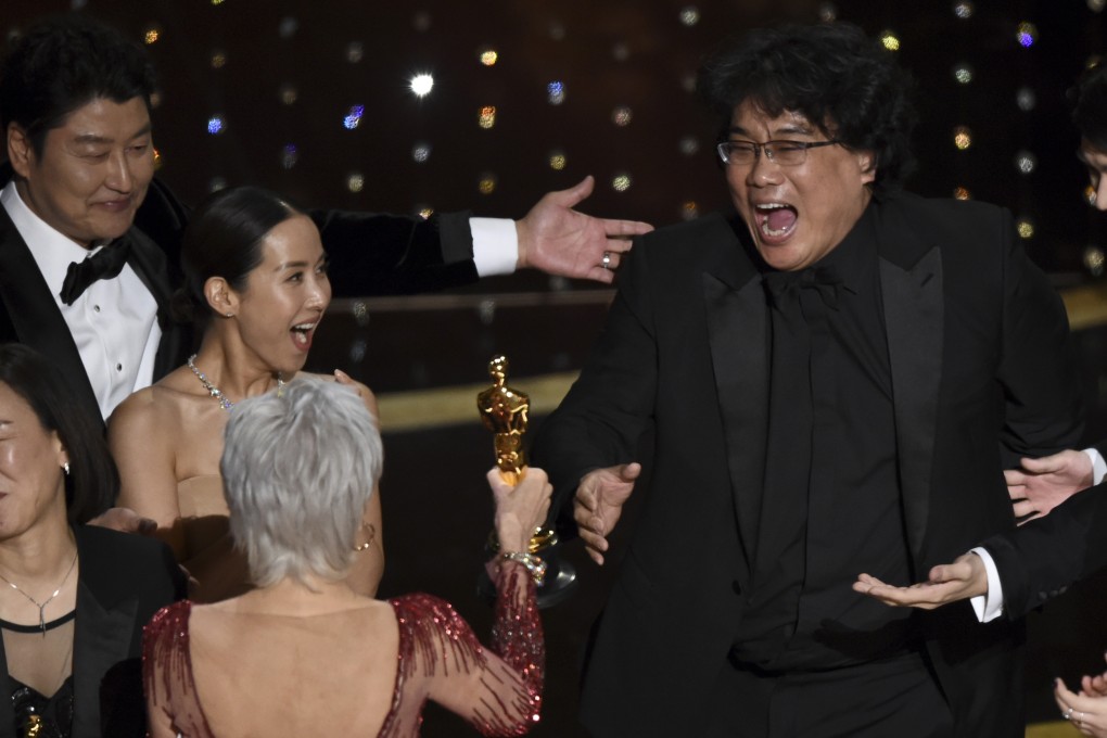 Bong Joon-ho (right) reacts as he is presented with the award for best picture for Parasite at the Oscars. Photo: AP