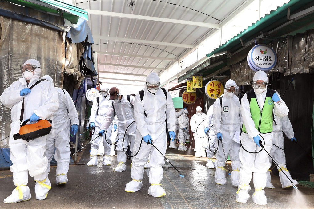 Workers spray disinfectant at a market in Bupyeong, South Korea. Photo: AP