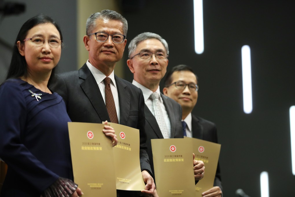 (L-R) Permanent Secretary for Financial Services and the Treasury (Treasury), Alice Lau Yim; Financial Secretary Paul Chan Mo-po; Secretary for Financial Services and the Treasury, James Henry Lau; and Andrew Au, Government Economist, poses for photos during the press conference after the delivery of the 2020-21 budget, Central Government Offices, Tamar. 26FEB20 SCMP / Winson Wong