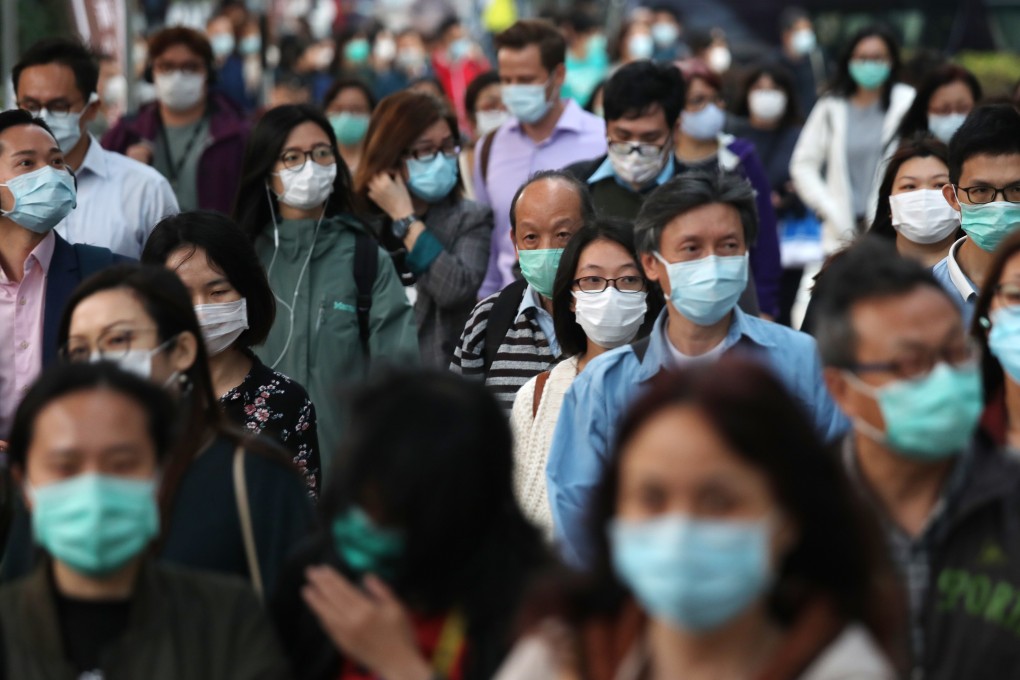 Pedestrians wearing masks in Kowloon Bay. 27FEB20 SCMP / Xiaomei Chen