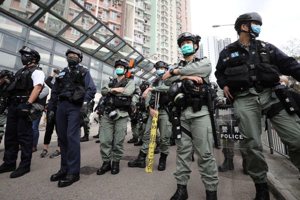 Anti-riot police on watch as protestors march in against the use of the South Kwai Chung Jockey Club Polyclinic to receive coronavirus patients. Photo: Dickson Lee