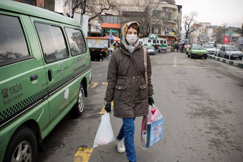 An Iranian woman wears a face mask as she walks in northern Tehran on Wednesday. Photo: dpa