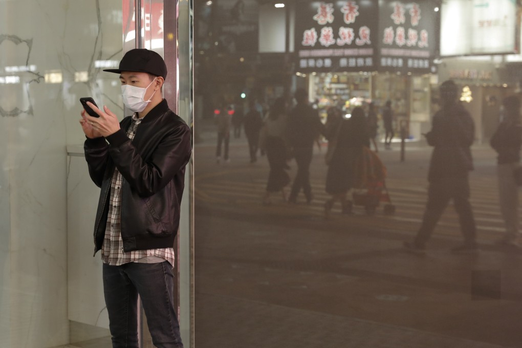 A man uses his phone on a street in Causeway Bay, Hong Kong. Photo: Sun Yeung