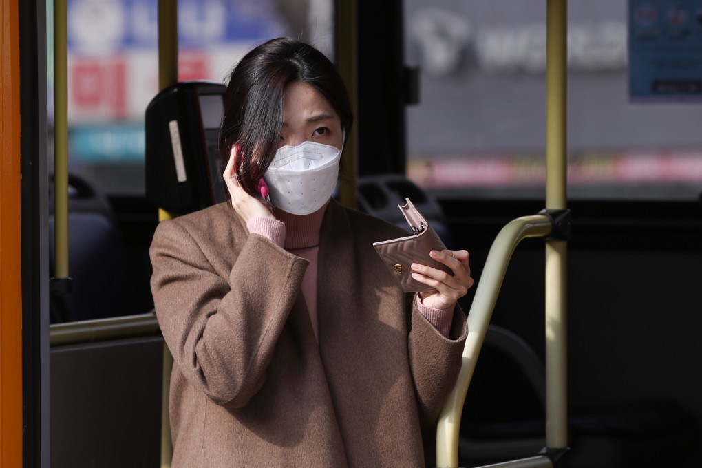 A bus passenger in Seoul wears a face mask as protection from the new coronavirus. Photo: Xinhua