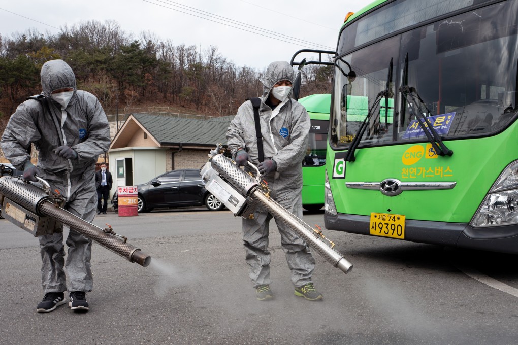 Workers spray disinfectant at a public bus car park in Seoul on February 26, 2020. Photo: EPA-EFE