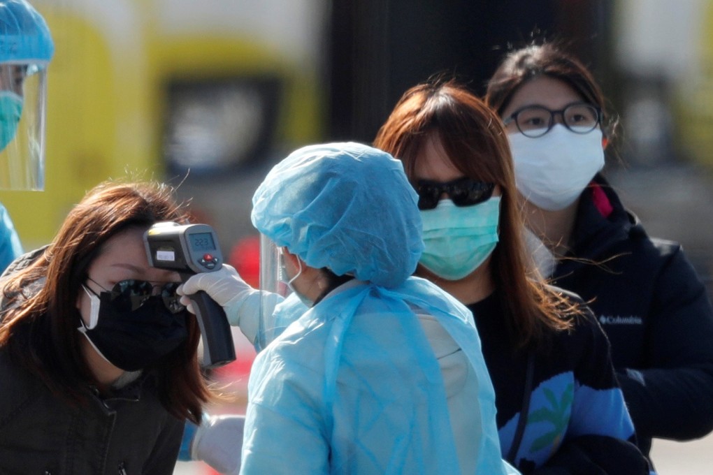 A Diamond Princess passenger has her temperature taken upon leaving the coronavirus-hit cruise ship on February 21, 2020. Photo: Reuters