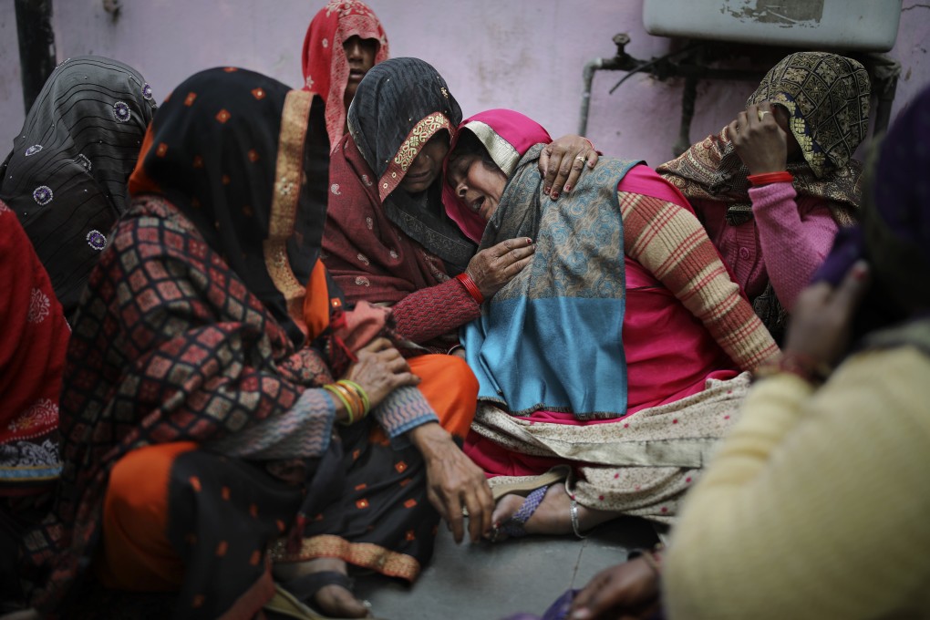 Family members of a man, who was killed in mob violence, weep outside a mortuary in New Delhi. Photo: AP