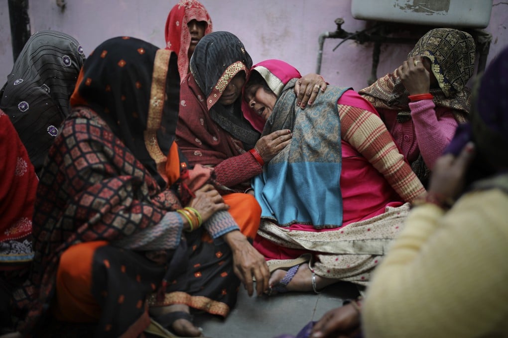Family members of a man, who was killed in mob violence, weep outside a mortuary in New Delhi. Photo: AP